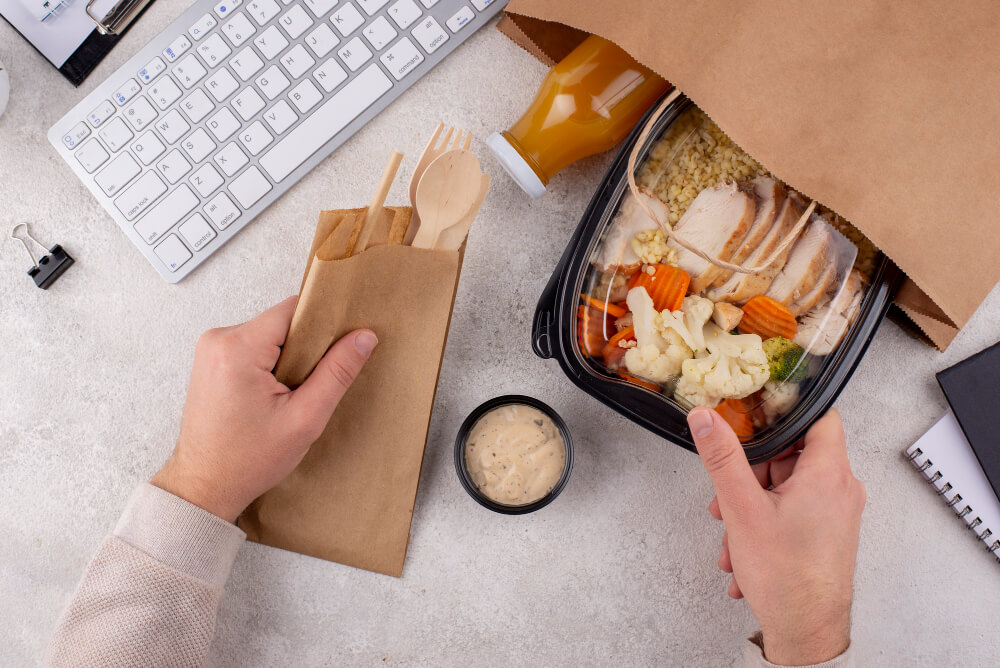 close up hands holding food pack